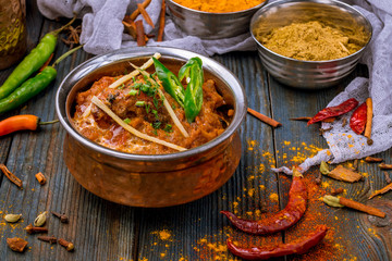 chicken tikka masala Indian food on wooden background with spices