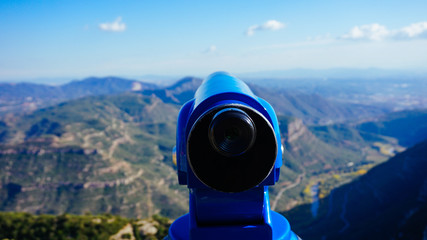 Fototapeta na wymiar Blue telescope at the top of a mountain