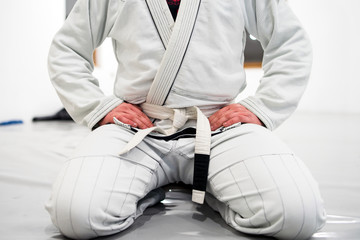 Brazilian Jiu JItsu BJJ WHite Belt Fighter Sitting in training