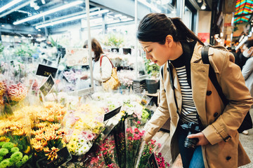 beautiful traveler buying flora in brocade market