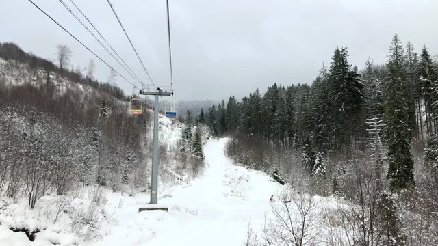 View from the chair to the chair lift at a ski resort in winter.
