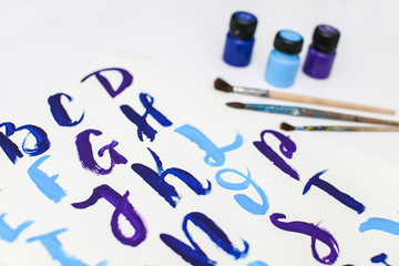 Calligraphy lettering alphabet drawn with dry brush. Letters of English ABC written with paint brush