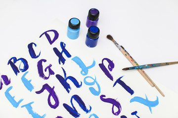 Calligraphy lettering alphabet drawn with dry brush. Letters of English ABC written with paint brush