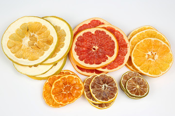 mix of different pieces of dried citrus fruit on white background