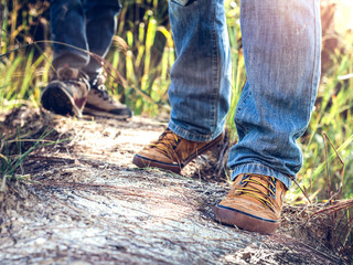 Close up shoes of hiker man on mountain trail. travel concept.