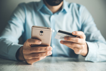 man hand credit card with phone
