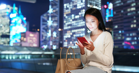 Woman use of smart phone in city