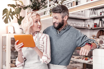 Joyful positive couple looking for new ideas