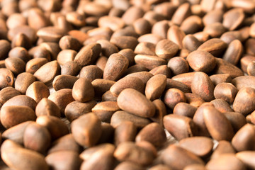 Pine nuts background texture. Selective focus