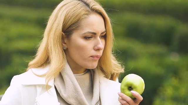 Pregnant lady with big belly feeling sick after biting apple suffering toxicosis