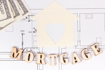 Inscription mortgage and money on construction diagrams of house