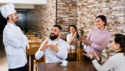  Happy chef listens to praise of the food