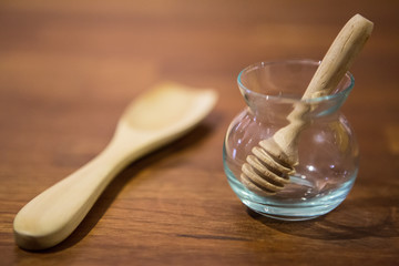 empty honey jar on a wooden table