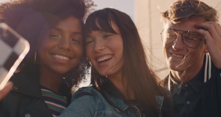 slow motion happy rooftop party friends having fun young asian woman taking group photos using smartphone sharing weekend lifestyle on social media at sunset - Powered by Adobe