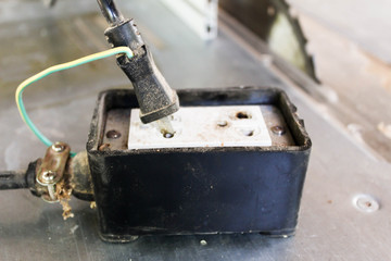 Old and Damaged  black plug is being used on the floor.