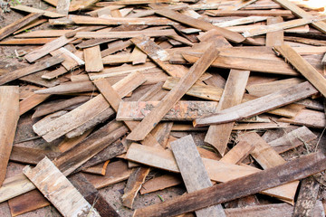 Old scattered boards or wood panels from demolition placed on the floor.