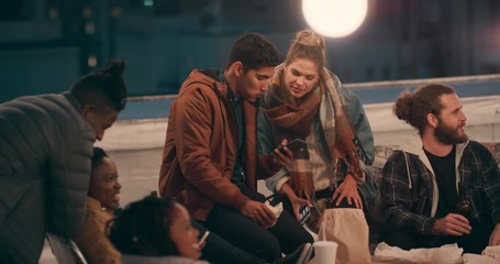 diverse rooftop party friends hanging out chatting having fun socializing together texting on smartphone enjoying happy reunion gathering at night - Powered by Adobe