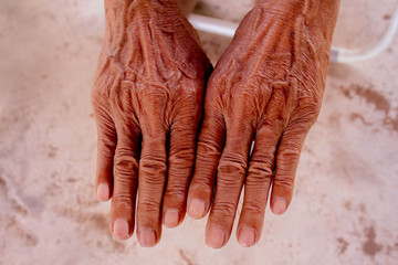 Close up hands of elderly Asian man.