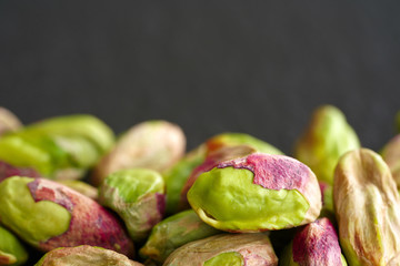 peeled pistachios on the black stone board