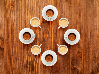 Some cups of coffee on wooden table, top view. Coffee brake concept.