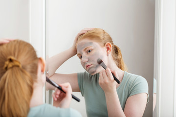 teen girl puts on  face mask