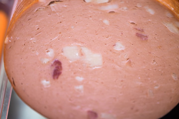 Bologna sausages showed at refrigerated store window © vadiml