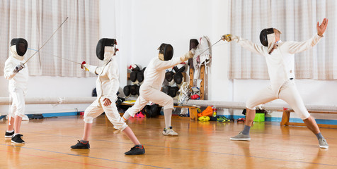 Obraz premium Mixed age group people at fencing workout