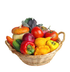 Vegetables in a basket. Pumpkins, tomatoes, onions, peppers. Isolated on white