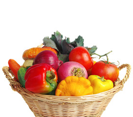 Vegetables in a basket. Pumpkins, tomatoes, onions, peppers. Isolated on white