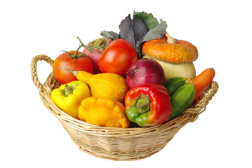 Vegetables in a basket. Pumpkins, tomatoes, onions, peppers. Isolated on white