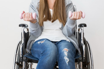 Disabled woman exercising with dumbells.