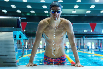 A professional swimmer emerges from the pool.