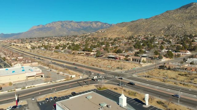 Aerial timelapse shot of cars traveling down tramway road with a great view of the Sandia Mountains in Alb, NM.