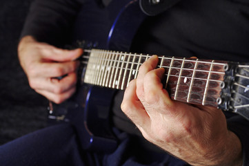 Fototapeta na wymiar Guitarist hands playing guitar