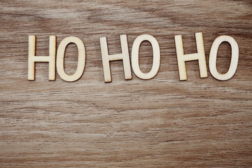 ho ho ho Santa exclamation lettering on wooden background Christmas concept