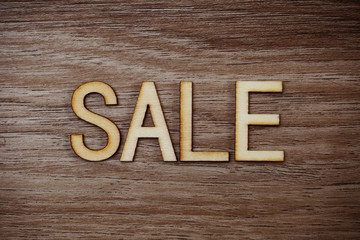 Sale Alphbet Letters on wooden background business concept