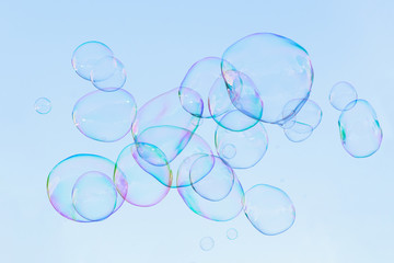 Lot of soap bubbles are flying in the sky.