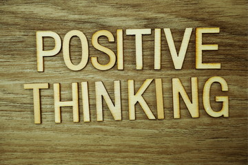 Positive Thinking text message on wooden background