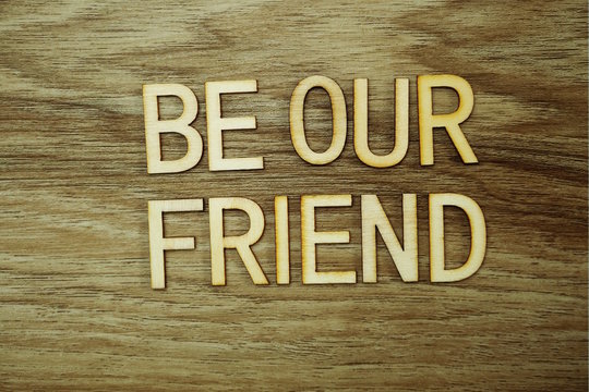 Be our Friend text message on wooden background