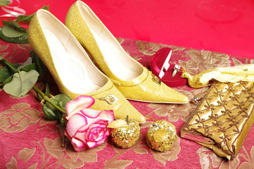 Women's shoes, a rose, a clutch bag and a jewelry gift