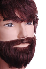 Male mannequin with a beard and long hair. Hairdressing