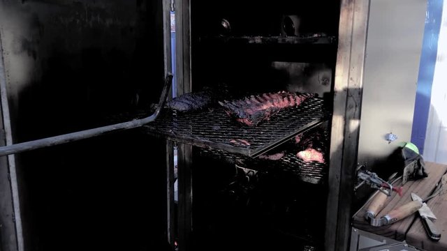 Baby back ribs being smoked in a huge home built smoker