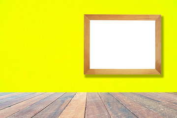 Yellow wall and empty wood desk and Wooden frame .Blank space for text and images.