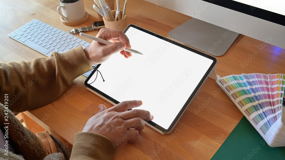 Fototapete cropped shot of designer using graphics tablet while working with computer at studio or office