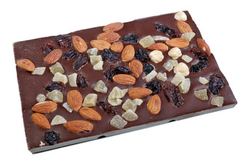 Tile of  homemade chocolate with pieces of dry fruit and nuts isolated