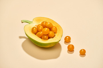 vegetables and fruits: cherry tomatoes and papaya isolated on pastel background for vegans and vegetarians ready for product display or montag