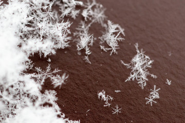 White snowflakes on nature as a background