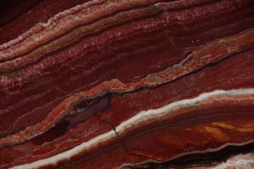 Natural stone of red color with an interesting pattern called Onice Fantastico