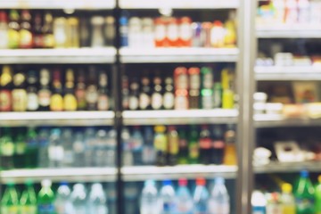photo blurred  Drink products Beverage soft drink bottles in  supermarket refrigerator Variety of...
