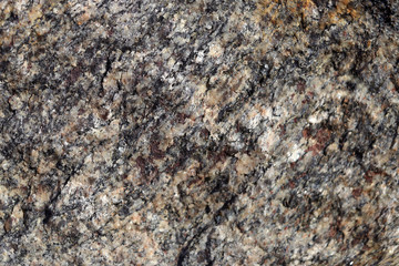 Background texture of natural stone. Black and white mixture of the surface of the stone. Cropped shot, close-up, horizontal, free space for text. Nature's concept.